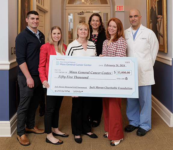 Family members and MGH Team with donation check