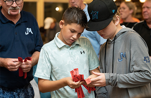 boys checking raffle tickets